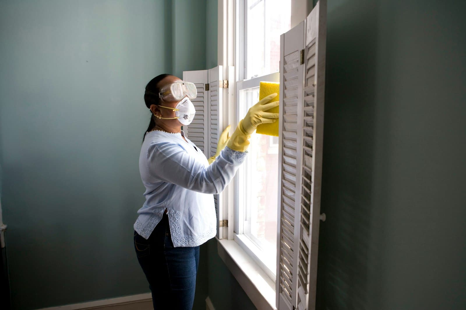 Professional cleaner maintaining a bright office space